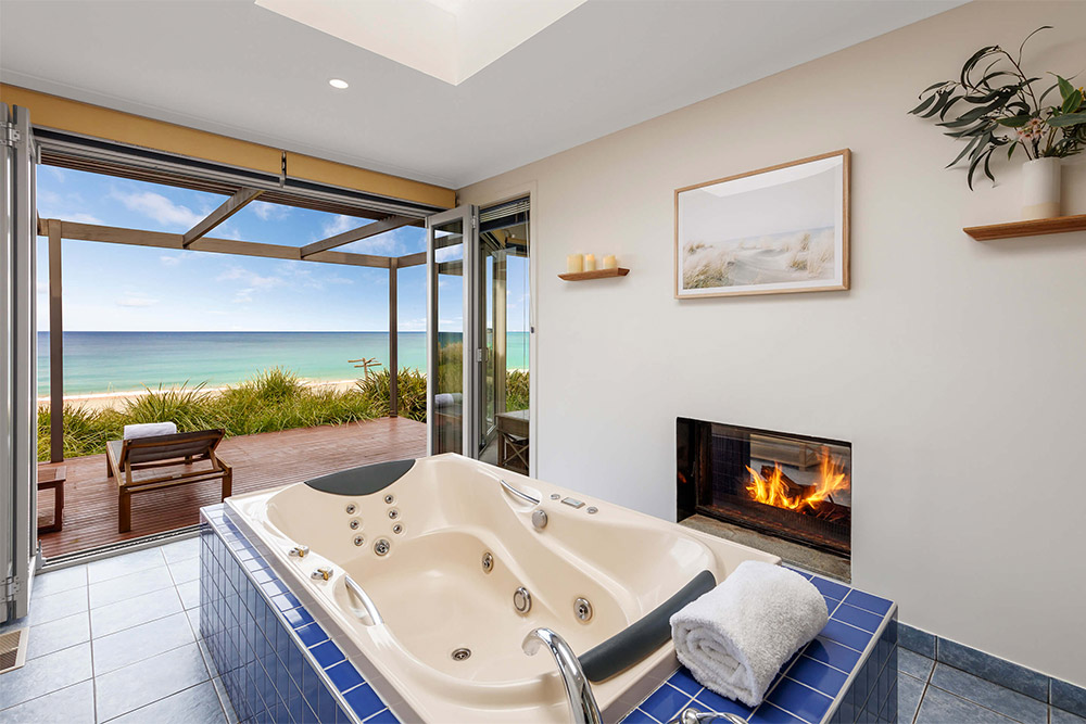 Luxurious double spa bath with ocean views and beachfront with fireplace